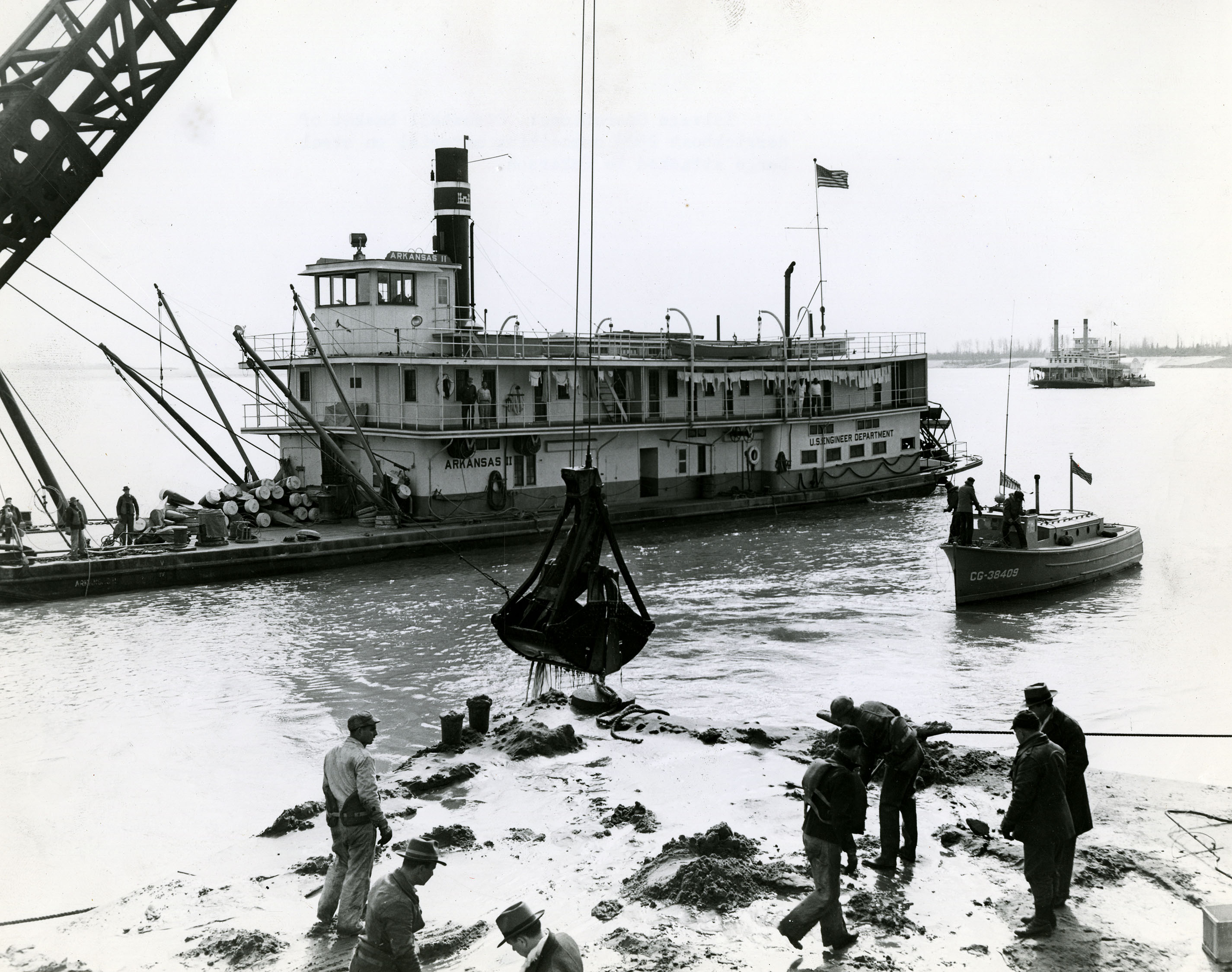 a pile of metal debris on a barge, large boat in background a pile of metal debris on a barge, large boat in background
